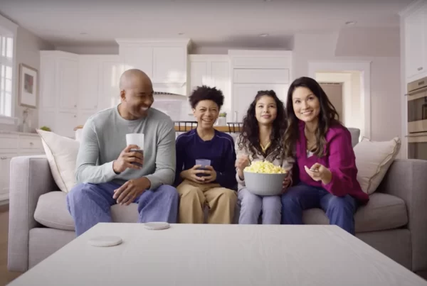 Family around watching TV via Tablo