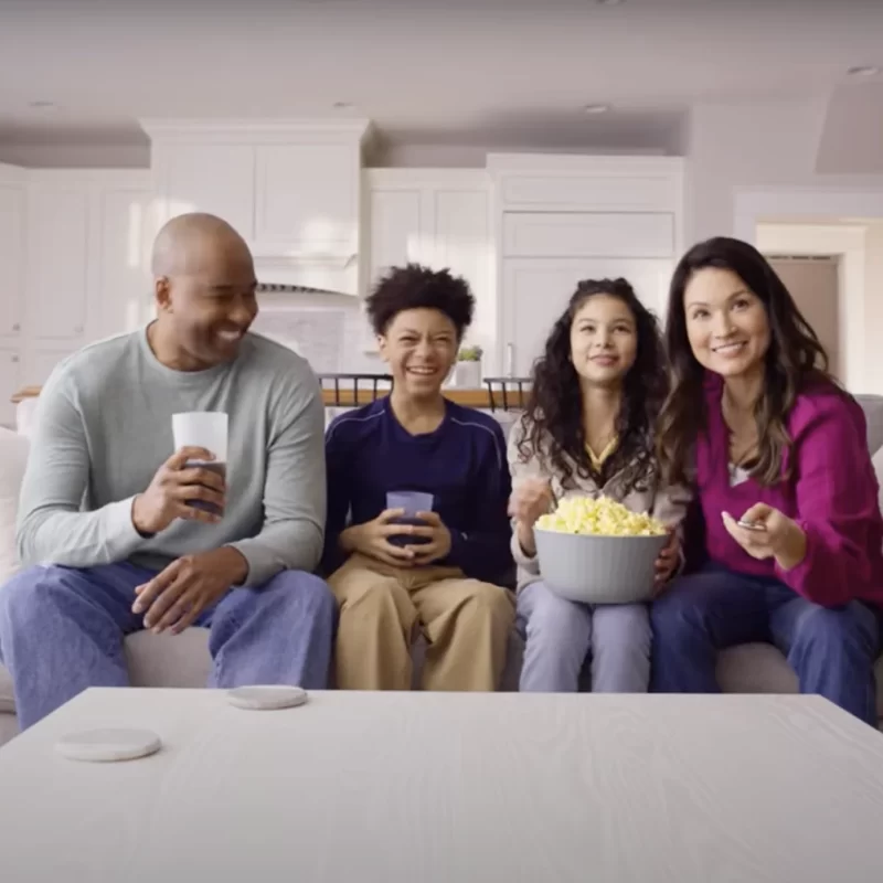 Family around watching TV via Tablo